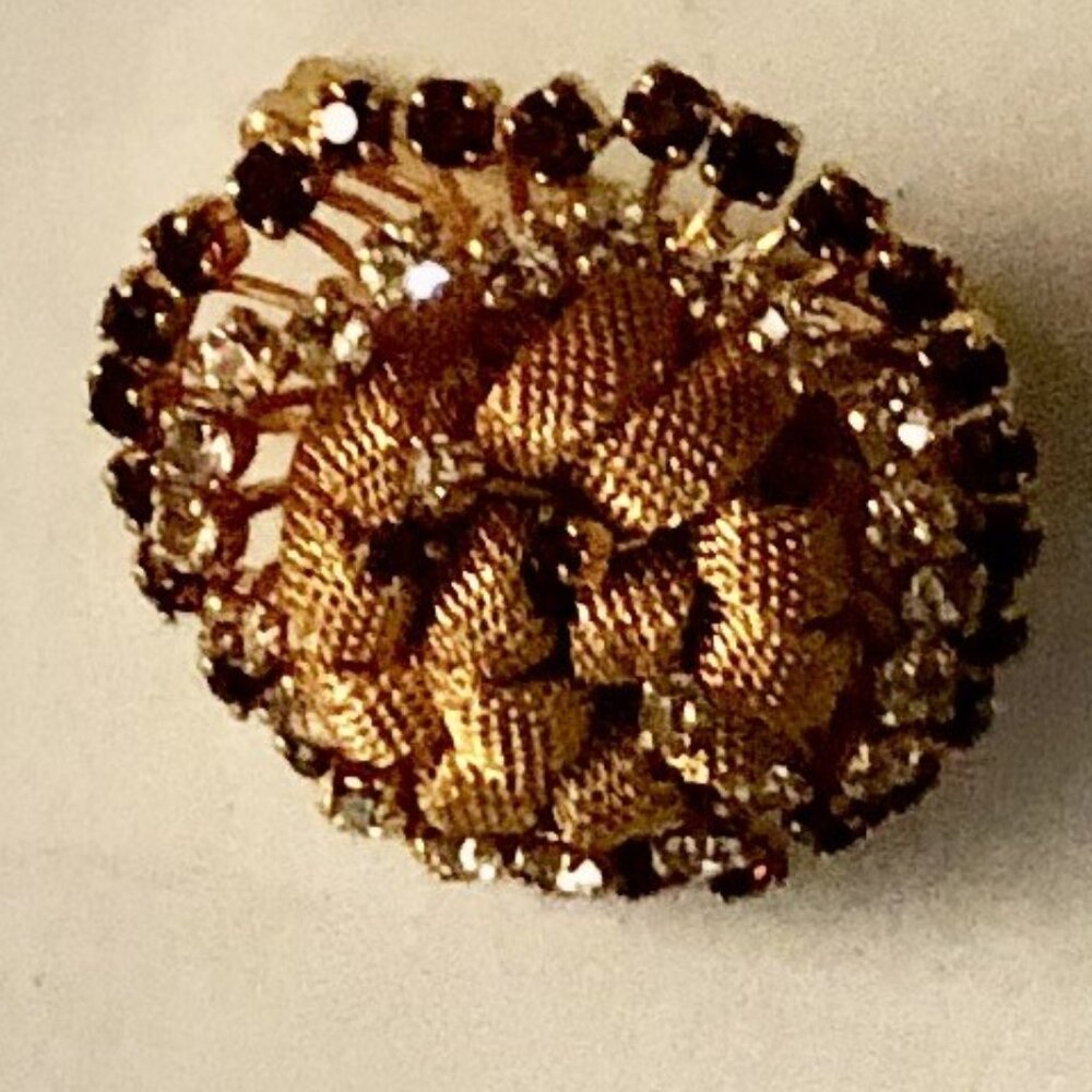 A vintage garnet and white cz brooch on a gold bed medium size medium